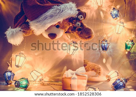 Christmas card with two stuffed toys Teddy bear, gifts and fairy lights garland. Greeting xmas card with peace from your test..