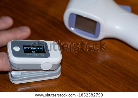 Man using pulse oximeter to measure oxygen saturation in covid19 pandemic disease,medical home monitoring treatment