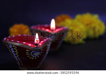 A decorative Indian Diwali lamp with a beautiful background. Happy Diwali poster or banner with free copy space.