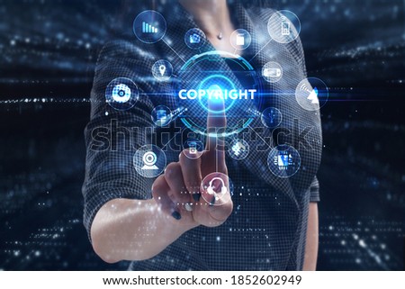 Business, Technology, Internet and network concept. Young businessman working on a virtual screen of the future and sees the inscription: Copyright
