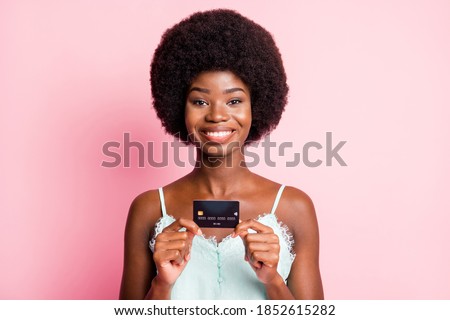 Photo of positive young woman show debit plastic card shopper buyer wear singlet isolated on pink color background