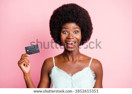 Photo of stylish crazy young woman hold credit card spend money discount wear singlet isolated on pink color background