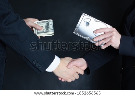 Crime scene: selling confidential information on the hard drive of competitors or officials for a bundle of US dollar bills. A man and a woman shake hands . Dark background.