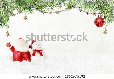 Santa Claus and snowman with spruce twigs and fistive decorations on white bokeh background with snowflakes frame for celebration New Year and Christmas