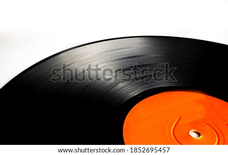 Classic vinyl record, old black color on a white background and several discs, long play and single.
