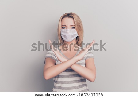 Photo portrait of girl with crossed arms refusing wearing white face mask isolated on grey colored background