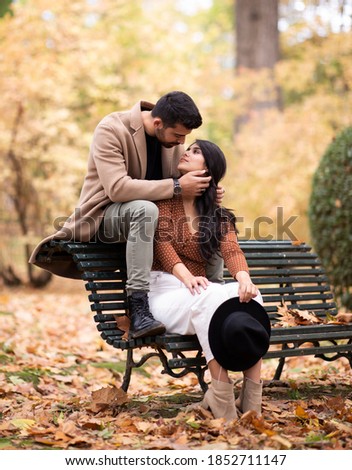 
couple in love sitting in a park vanity