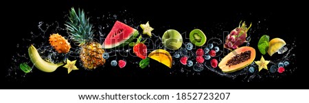 Panoramic wide black background with assortment of fresh fruits and water splashes. High resolution collage for skinali Royalty-Free Stock Photo #1852723207