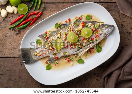 Steamed Seabass with Spicy Chili and Lemon Sauce.Top view Royalty-Free Stock Photo #1852743544