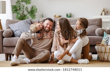 happy family mother father and children at home on floor next to the sofa
 Royalty-Free Stock Photo #1852748011