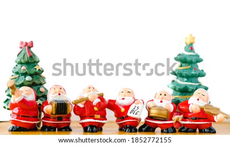 Santa claus sing a song on Christmas caroling day or Carolers singing with snows.Group of Santa claus play music sing carol song on celebration of christmas day party in winter.Celebration Holidays.