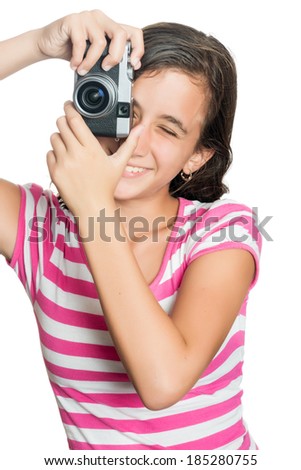 Fun happy young girl taking a photo with a vintage looking compact camera looking through the viewfinder (isolated on white)