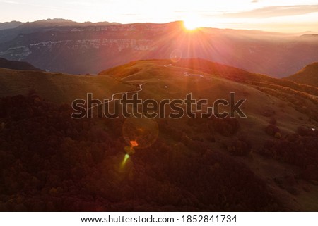 Sunrise beyond the road in the mountains