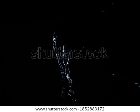 Dramatic water fall against dark background