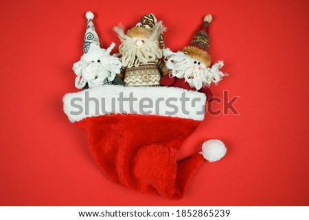 Christmas gnomes toys in santa hat. Time for Christmas shopping concept. Blank red space for text.