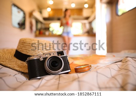 Composition with travel accessories on bed in motorhome, closeup. Summer trip