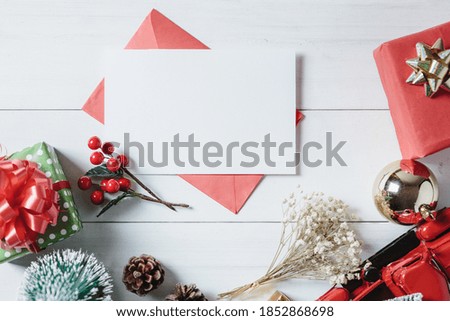 Christmas card and Christmas ornament and decoration on white wooden plank.