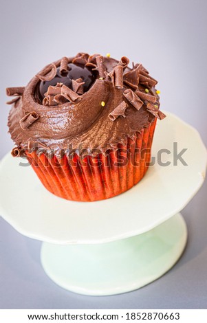 Homemade chocolate cup cake on a presentation stand