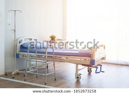 Clean and hospitality of room with empty bed and medical equipment in hospital. Royalty-Free Stock Photo #1852873258