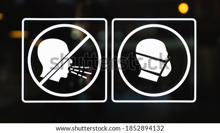 Quarantine sign on the door of restaurant window or shop showcase. Mandatory to wear mask inside. Corona virus concept