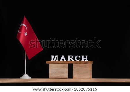 Wooden calendar of March with Turkish flag on black background. Holidays of Turkey in March.