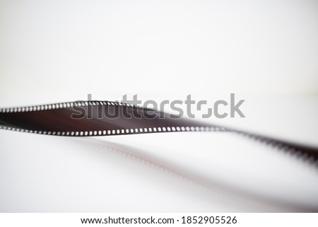 Blank old 35mm photographic filmstrip reel isolated on white background 