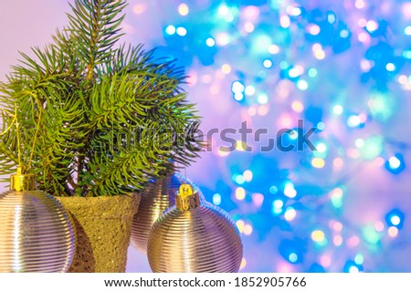 Fir tree and decorative spheres on christmas lights background
