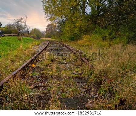 Railroad tracks with a dramatic sunset in the background. Picture from Scania county, Sweden