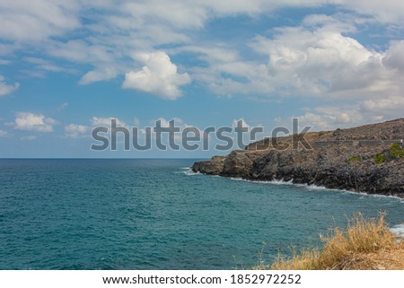 Seascape. The rocky coast of their cloud in the sky. Stock photography