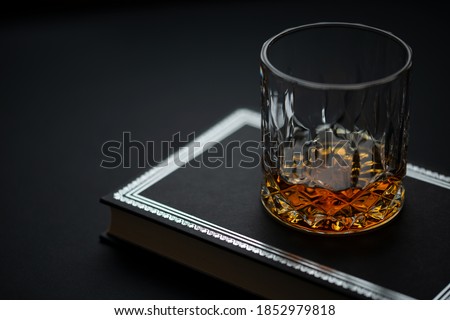 Golden brown whiskey in a glass on a dark background. Royalty-Free Stock Photo #1852979818
