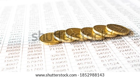 money coin on accounting report sheet background, Saving money or finacial concept.