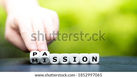 Do your mission with passion. Hand turns dice and changes the name "mission" to "passion". Royalty-Free Stock Photo #1852997065