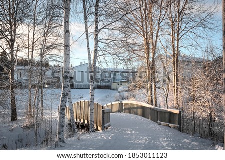 Winter landscape. Wooden bridge. Sunny day. City. Winter in Finland.