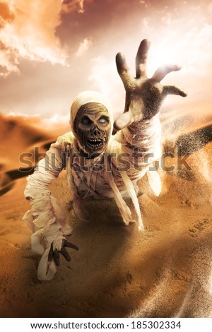 Scary Halloween mummy in hot desert with dramatic lighting