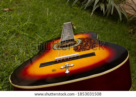 Guitar on grass with white crucifix