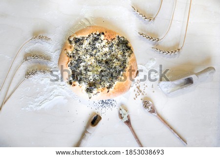 Photo flay lay on the kitchen table with flour and poppies, onion cake as a regional dish of the Lublin,  Poland Royalty-Free Stock Photo #1853038693