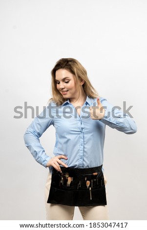 Photo of a woman on a light background. She has a makeup artist's kit. The girl looks down. High quality photo.