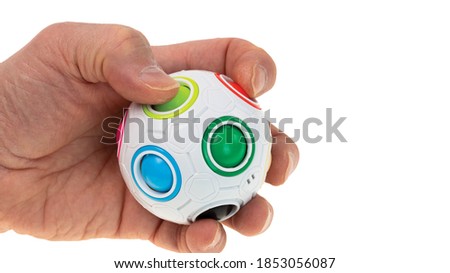 Close up view of colorful anti stress toy in man's hand. Stress and health concept.