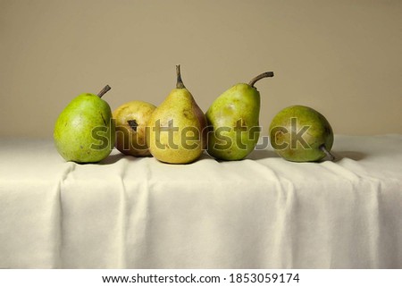 
Composition of fruit, with green ripe pears on the table on a plain background Royalty-Free Stock Photo #1853059174