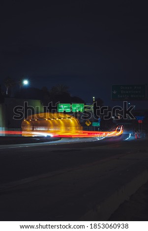Night time traffic and light trails from the PCH onto 10 freeway from Santa Monica Beach towards LA