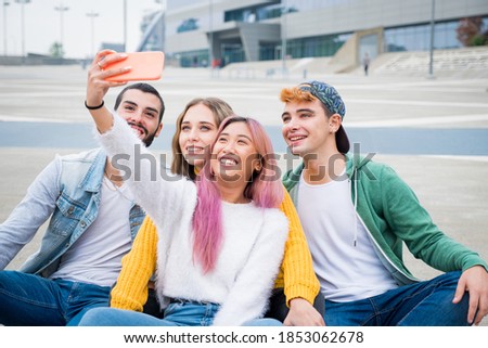 Group of teneegers laughing and jocking together while doing a videocall with theyrs friends - Group of friends in holiday taking a selfie for remember this special moment