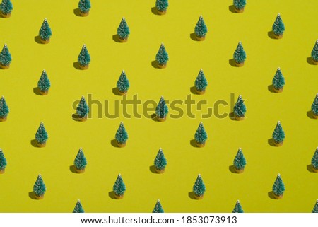 Christmas trees pattern, spruce woods on yellow background. Christmas, New Year, winter holidays concept.