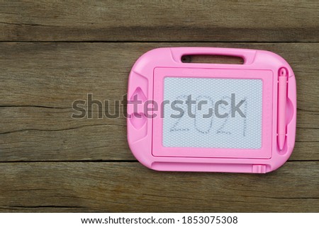 2021 text in pink frame on the old wooden floor for design in your work Christmas and New Year.