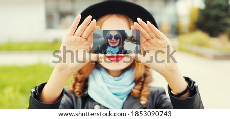 Close up of woman stretching her hands taking selfie picture by phone outdoors