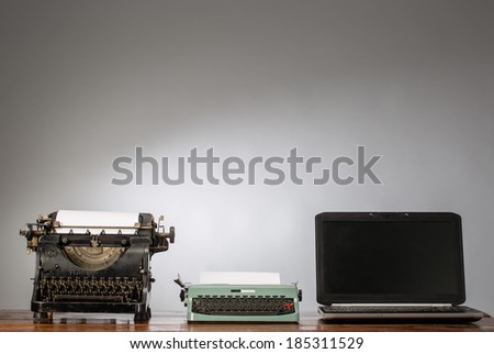 Vintage typewriter and laptop Royalty-Free Stock Photo #185311529