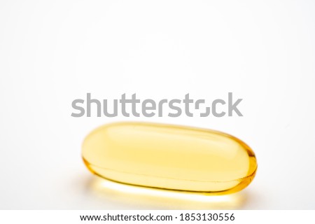 Fish Oil Pill macro photo isolated on white background