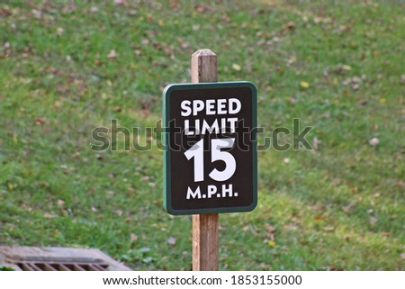 Wooden speed limit sign along the park road