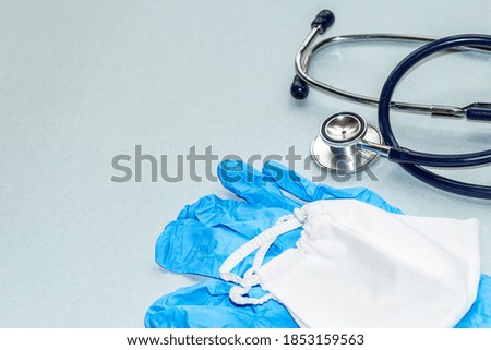 Medical concept. the medicine . GLOVES, PROTECTIVE MASK, STETHOSCOPE ON THE TABLE