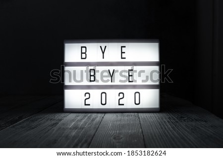 Lightbox with text BYE BYE 2020 in dark room. Hope, new life and Happy New Year 2021 concepts - Image