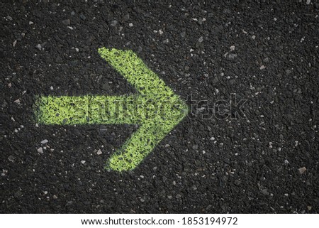 One arrow on a dark asphalt road, road sign for information,  
